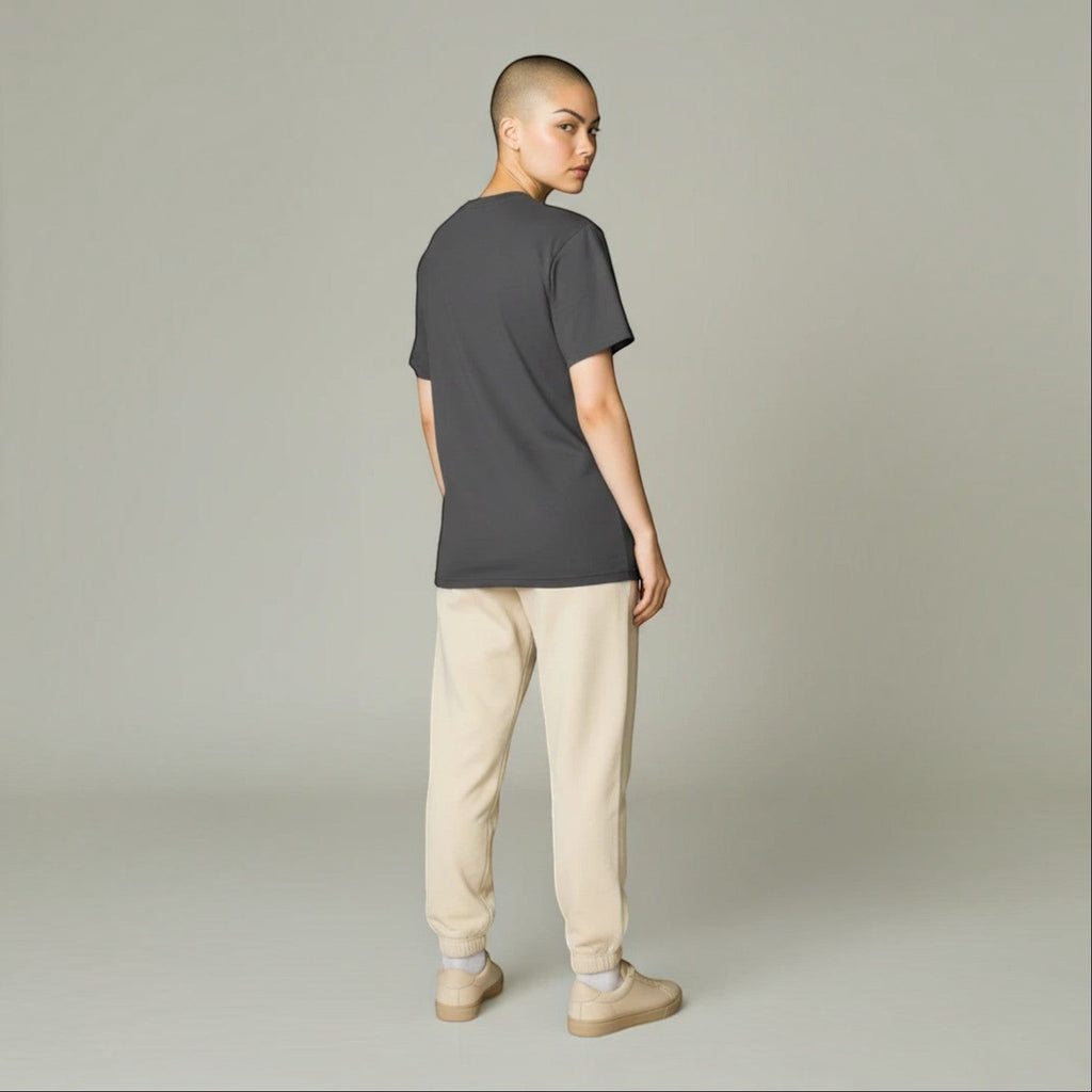 PAPPAREL model wearing a charcoal grey heavyweight crewneck t-shirt with beige joggers, back view