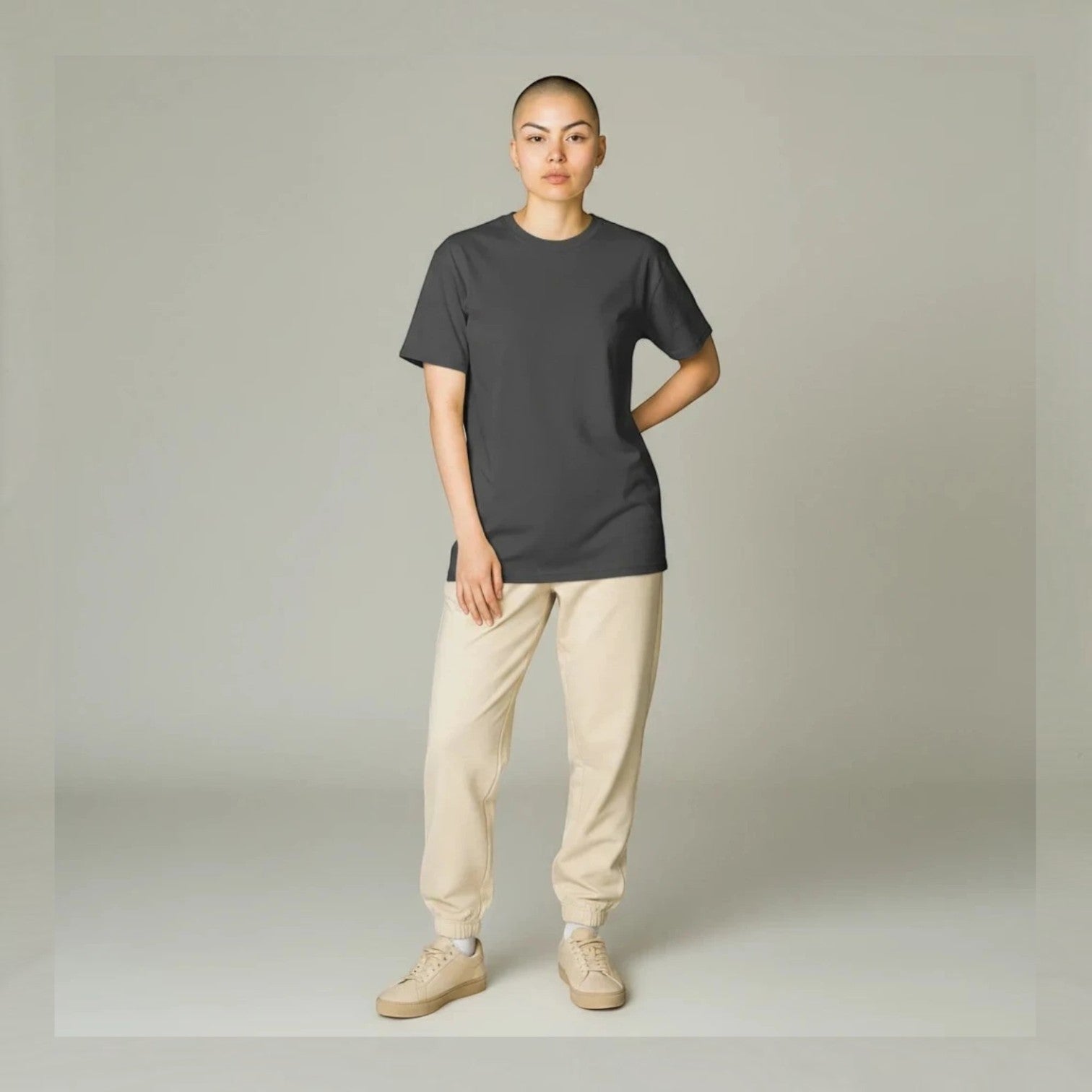 PAPPAREL heavyweight vintage crewneck t-shirt in charcoal grey worn by a model with beige joggers and sneakers.