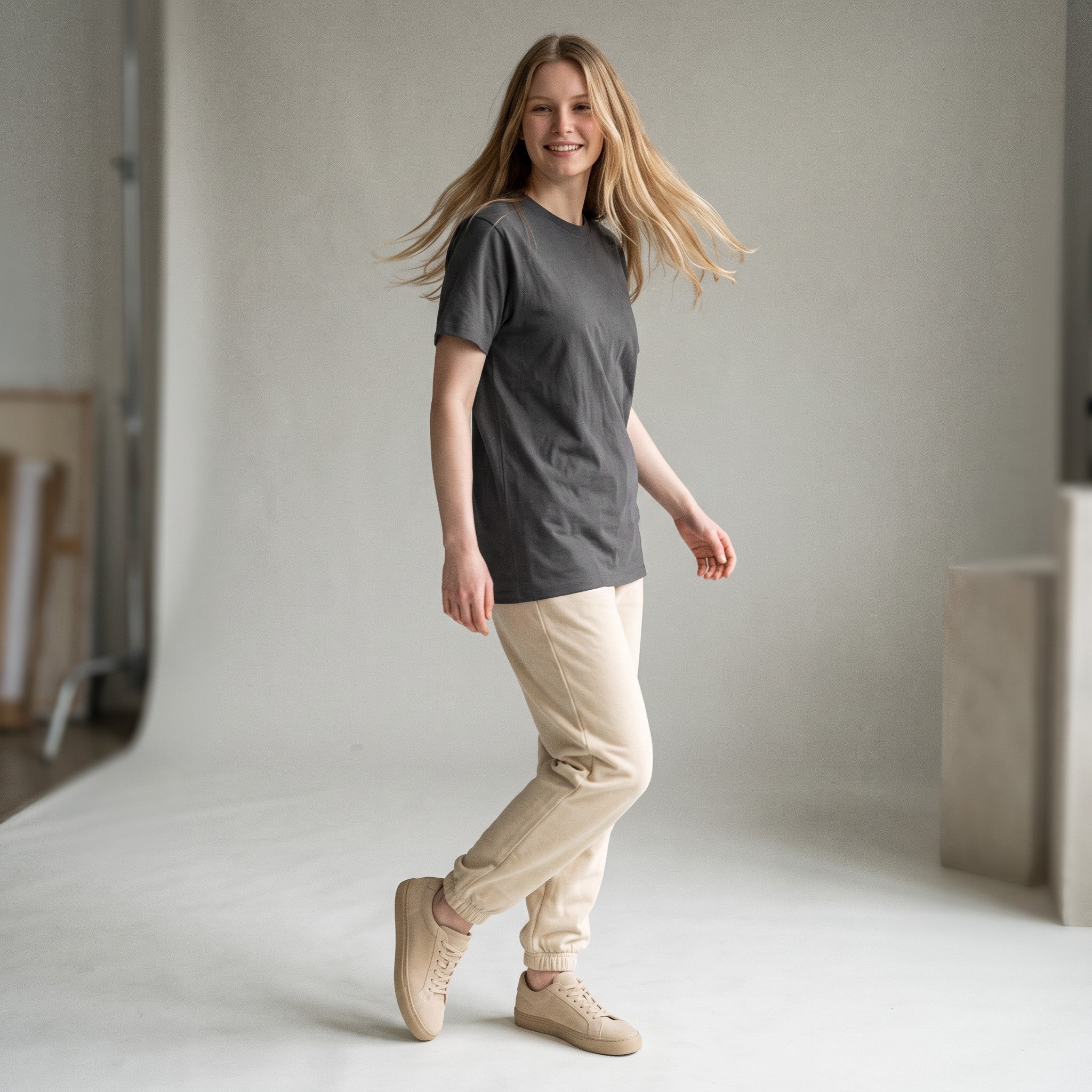 PAPPAREL model wearing a charcoal grey heavyweight vintage crewneck t-shirt with beige joggers in a studio setting