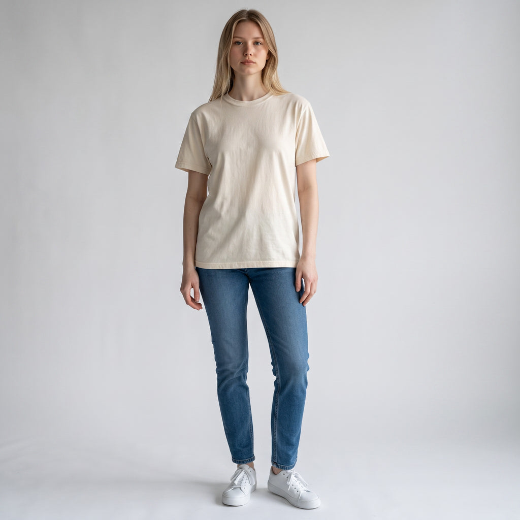 PAPPAREL model wearing a cream heavyweight vintage cotton crewneck t-shirt with blue jeans and white sneakers
