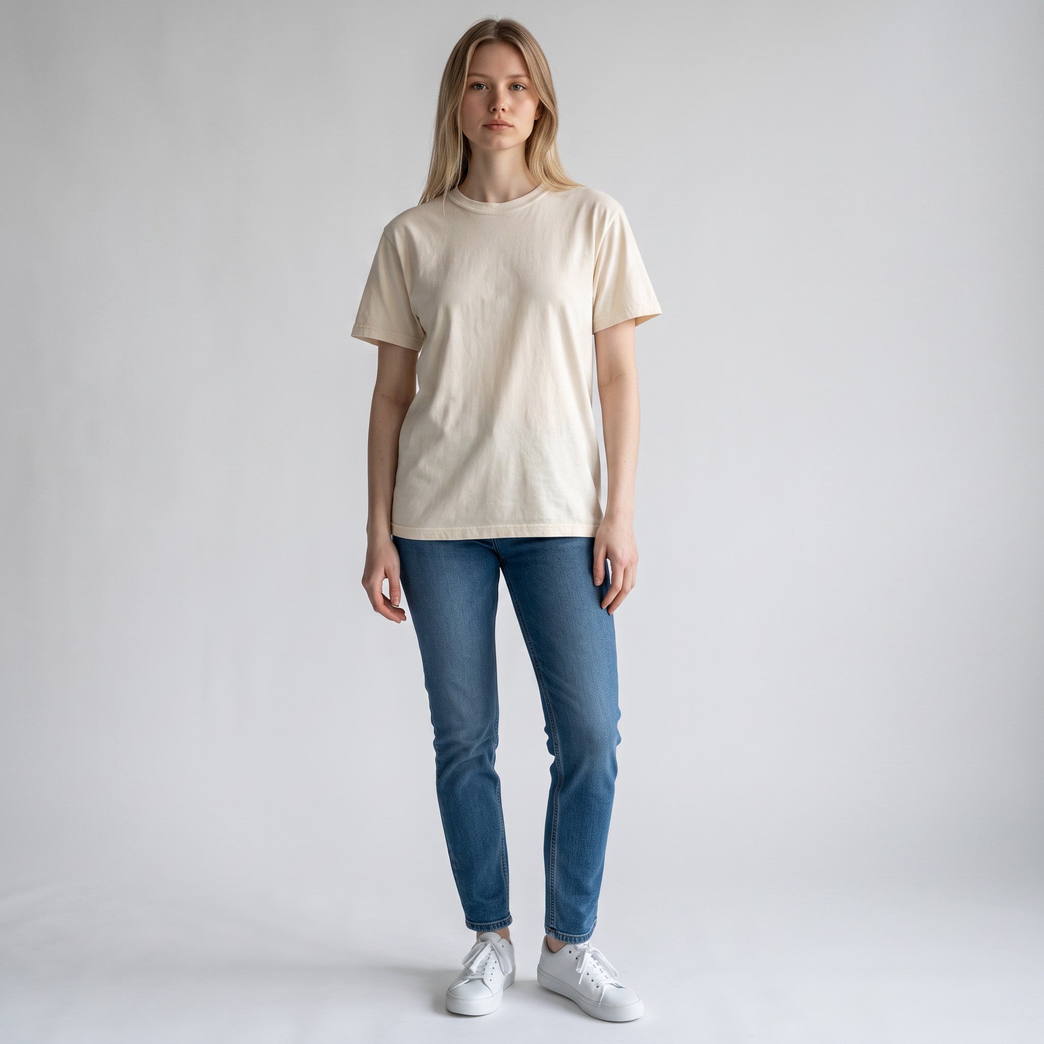 PAPPAREL model wearing a cream heavyweight vintage cotton crewneck t-shirt with blue jeans and white sneakers
